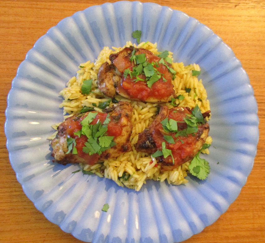 Chicken thighs Mexicana topped with salsa and cilantro.